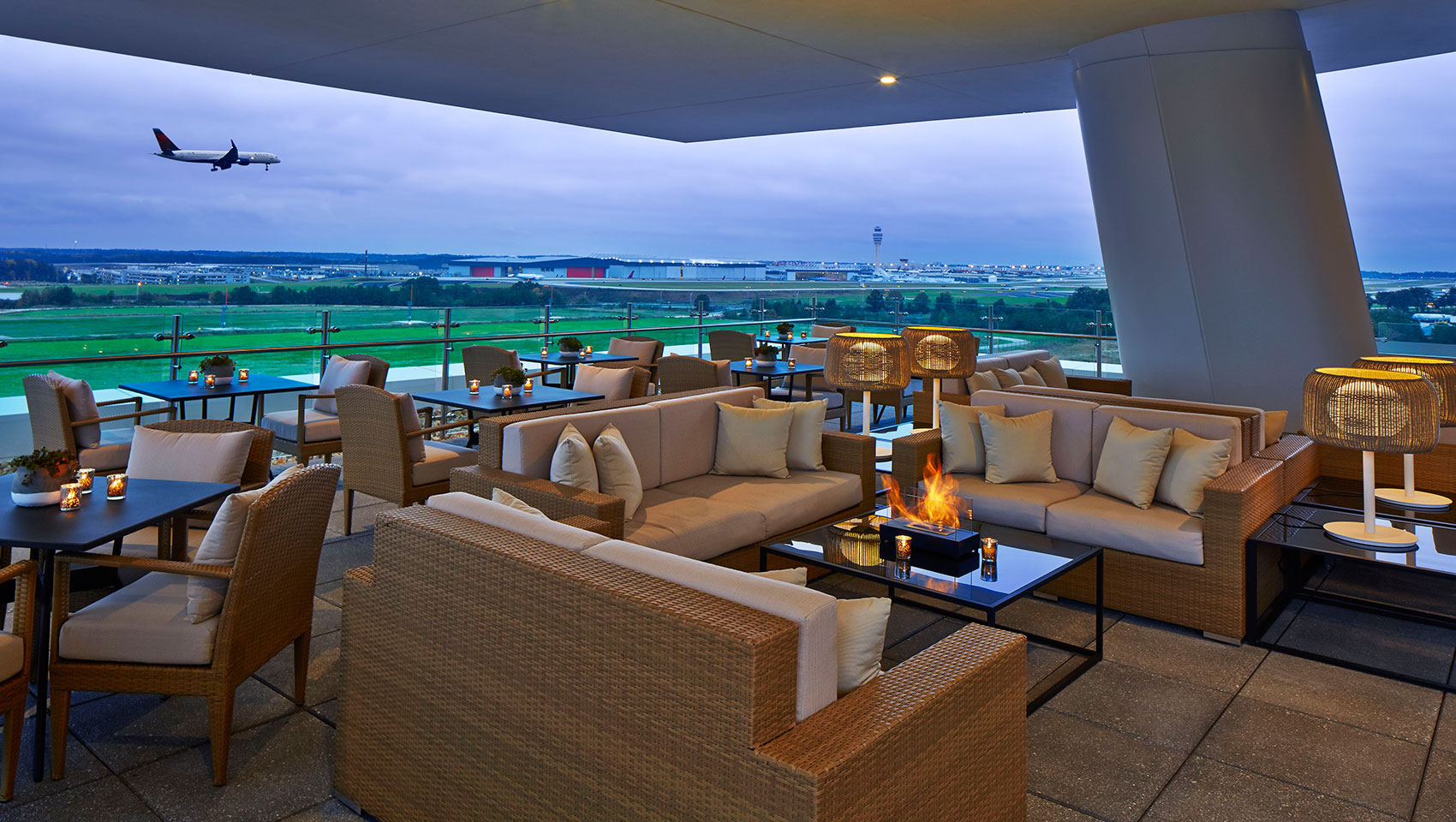 The Rooftop at Overland Atlanta, Airport hotel overlooking Atlanta’s International Airport with a plane on approach for arrival.